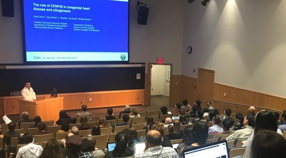 Audience looks at a PowerPoint slide in an auditorium
