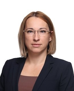 Person wearing glasses and dark jacket