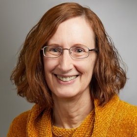 Person in glasses and a yellow sweater