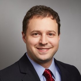 Smiling person in a suit and tie
