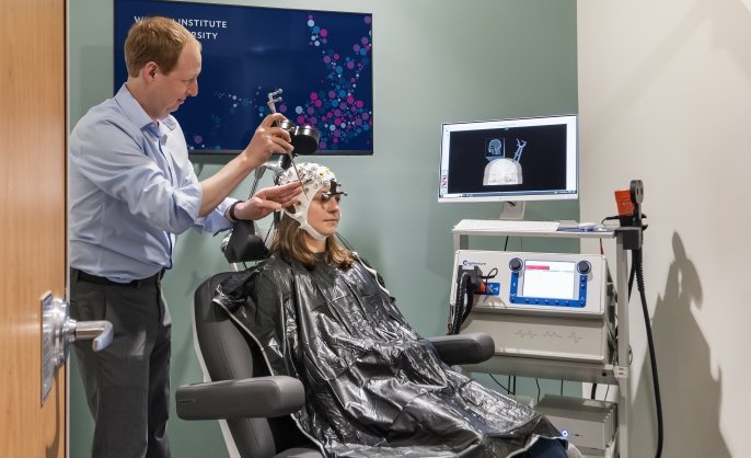 Researcher and participant in a TMS experiment. Photo by Anton Grassl, courtesy of SmithGroup