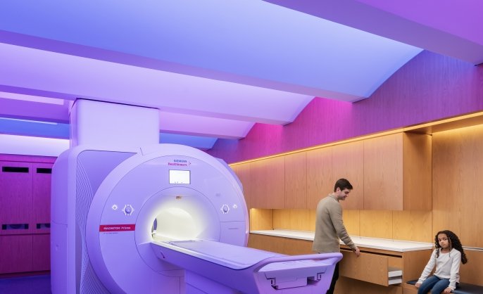 Scientist and participant inn the BrainWorks MRI. Photo by Anton Grassl, courtesy of SmithGroup