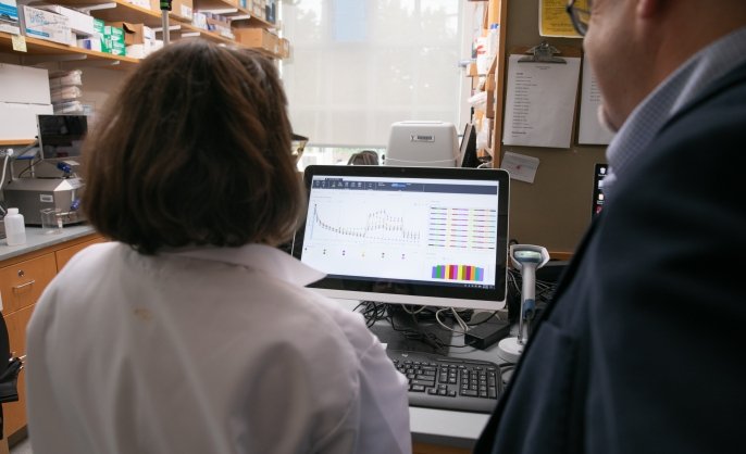 Two scientists examine a monitor