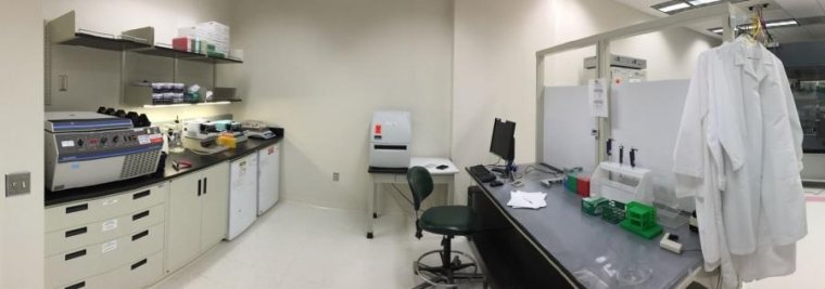 Two laboratory benches, chair, white coats